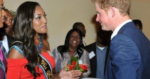 Prince Harry talks with Miss Bahamas 2011 Anastagia Pierre during a reception in Nassau